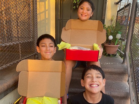 Three Kids holding the Signature Modern Art Box